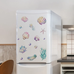 Detailed close-up of watercolor ocean starfish and shell stickers on a white fridge