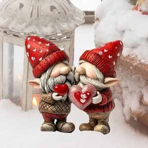 Close-up of Christmas gnome yard signs with heart motifs and warm holiday lighting