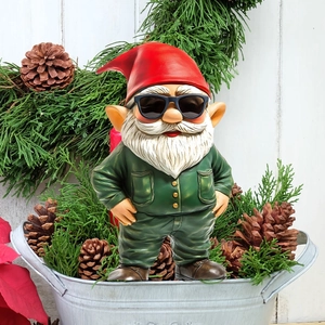 Detail of Christmas gnome with red hat and black sunglasses for garden holiday decoration
