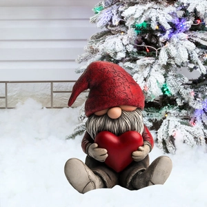 Christmas garden gnome stake decor with red heart and pointy hat in a snowy yard