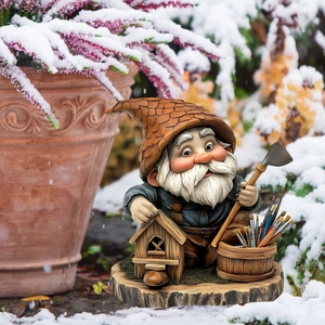 Detailed garden gnome statue with birdhouse and paint brushes on a snowy wooden base
