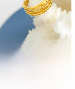 Macro view of gold wavy textured ring resting on white coral decoration detail