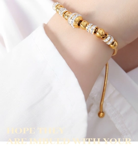 Detailed close-up of a 14K gold plated beaded bracelet with shimmering white zircon stones