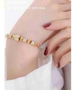 Detail of two-tone beaded bracelet with crystal accents worn on model's wrist