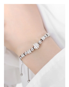 Detail of adjustable silver beaded bracelet with sparkling zircon stones on a female wrist