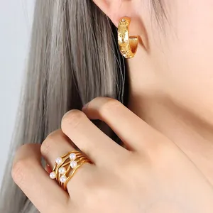 French palace style gold embossed celestial earrings and multi-layer pearl ring set