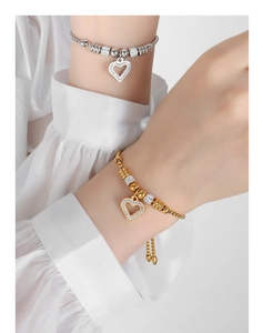 Close-up of heart-shaped gold and silver beaded bracelets with sparkling rhinestones