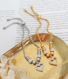 Detail of adjustable heart bracelets in gold and silver with cubic zirconia setting