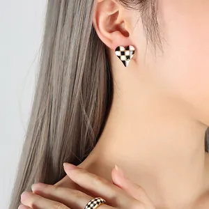 French design black and white checkered heart earrings and ring set on model