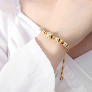 Elegant gold plated beaded bracelet with zircon inlay and adjustable snake chain on wrist