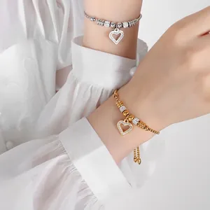 Elegant adjustable heart pendant bracelet in gold and silver finish with crystal inlay