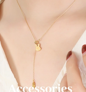 Close-up of golden bunny pendant necklace with carrot charm detail on a model