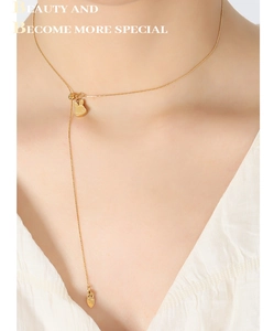 Detail of 18K gold-plated titanium steel necklace with bunny pendants and Y-shaped chain