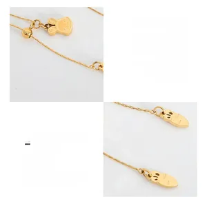Close-up of 18K gold plated rabbit pendant and carrot toggle on titanium steel necklace