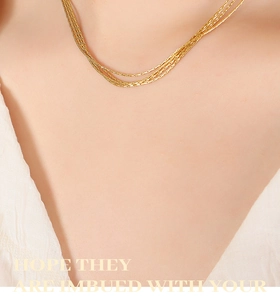 Detail of layered 18K gold plated multi-strand necklace worn on a female model