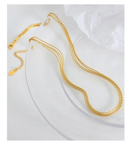 Detailed close-up of 18K gold-plated triple-layer chain necklace with K18 tag