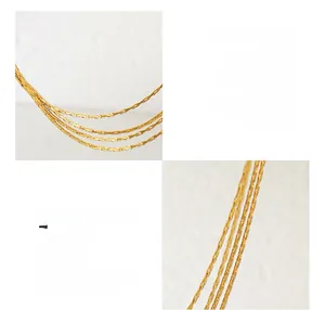 Detail of multi-layer 18K gold plated surgical steel chain showing polished finish