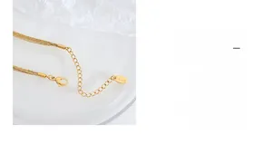 Close-up of 18K gold-plated multi-layer chain with lobster clasp and K18 hallmark tag