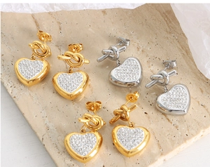 Detailed view of three pairs of heart earrings with sparkling cubic zirconia pavé