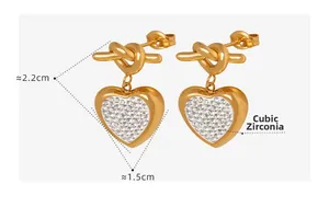 Detail shot of heart earrings with rhinestones showing dimensions 2.2cm by 1.5cm