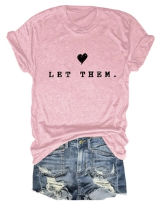 Flat lay of pink cotton LET THEM T-shirt paired with ripped denim shorts