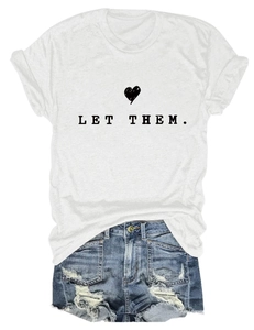 Flat lay of white cotton T-shirt with black heart print and distressed blue denim shorts