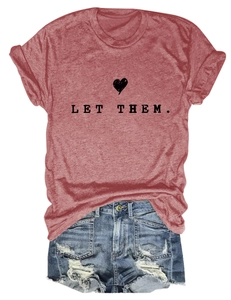 Flat lay of a red heather t-shirt with Let Them text and ripped denim shorts