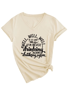 Detail of cream V-neck T-shirt featuring a black graphic slogan and trendy knotted hem