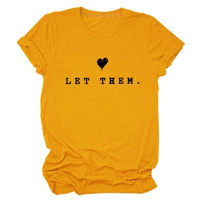 Close-up of yellow T-shirt with black LET THEM. lettering and heart graphic