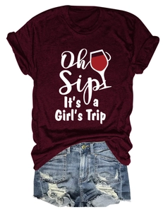 Dettaglio della t-shirt bordeaux stampata e degli shorts in denim blu con strappi