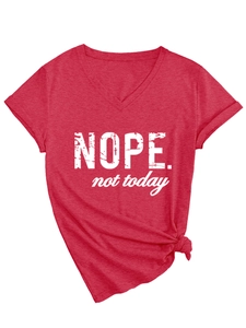 Detail of red V-neck T-shirt with 'NOPE. not today' slogan and stylish side-knot hem
