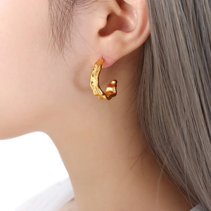 Irregular textured C-shaped gold earrings with lava molten metal design for women