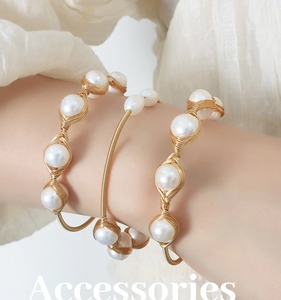 Detailed view of handmade brass wire-wrapped bracelets with baroque freshwater pearls