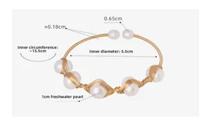 Detail view of handmade brass wire-wrapped bracelet with baroque freshwater pearls