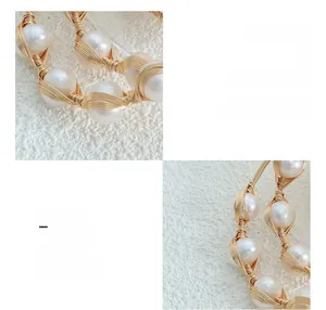 Macro detail of handmade brass wire-wrapped bracelet with white freshwater pearls