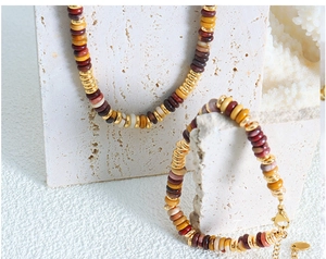 Detail of beaded necklace and bracelet set with natural stone discs and gold spacers