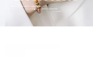 Detail of natural stone beaded bracelet with gold accents on wrist with white background