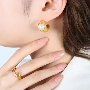 French vintage gold C-shaped pearl earrings and minimalist irregular ring set on model