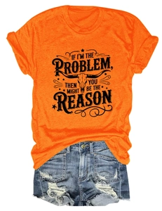 Close-up of orange graphic T-shirt with bull skull print and ripped denim shorts set