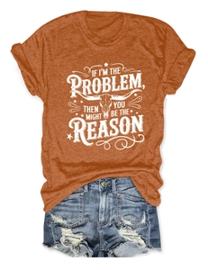 Flat lay of an orange vintage graphic tee with bull skull print and ripped denim shorts