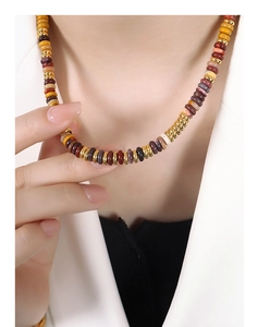 Detailed close-up of mixed natural stone beads and gold spacers on a vintage ethnic necklace