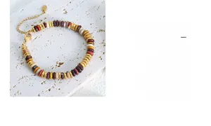 Detail of colorful stone beads and gold-plated metal spacers on a vintage style bracelet