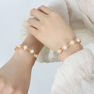 Handmade brass wire wrapped baroque freshwater pearl bracelet on a female model