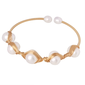 Handmade brass open cuff bracelet featuring seven white baroque freshwater pearls