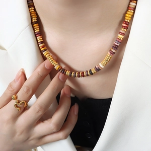 Bohemian mixed natural stone beaded necklace and wavy gold ring set on a model