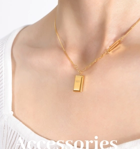 Detail of gold-plated square pendant necklace with GOLD engraving on model