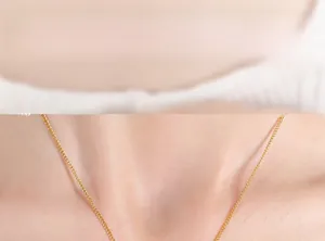 Close-up of golden letter square pendant necklace worn on neck for styling display