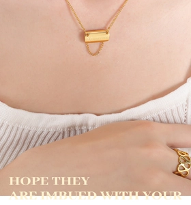 Detail of 18K gold plated square pendant necklace with tassel and matching hollow ring