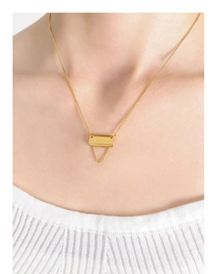Detail of 18K gold plated square pendant with engraved letters on a tassel chain necklace