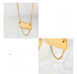 Detail of 18K gold plated titanium square pendant with engraved letter and thin chain